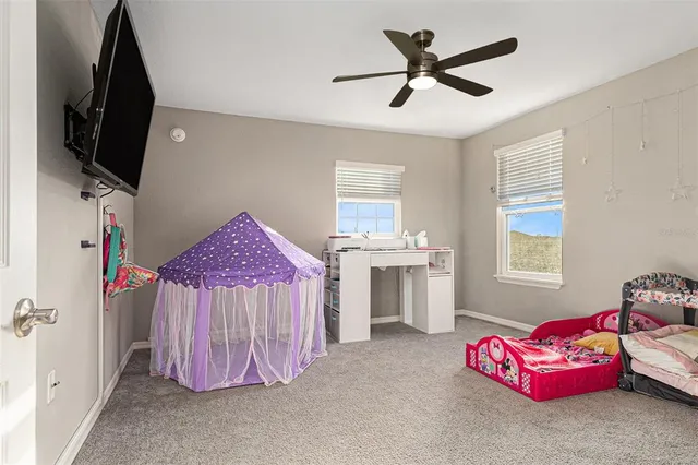 a bed room with furniture and flat screen tv