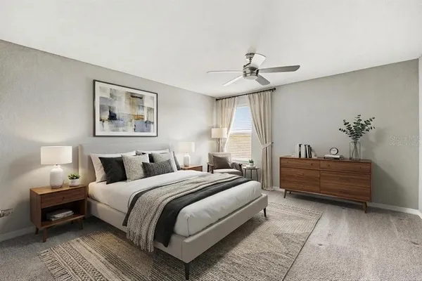 a spacious bedroom with a bed and a chandelier