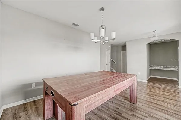 a room with a table and chandelier