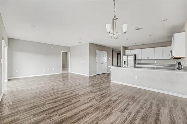 a view of a kitchen with wooden floor and a sink