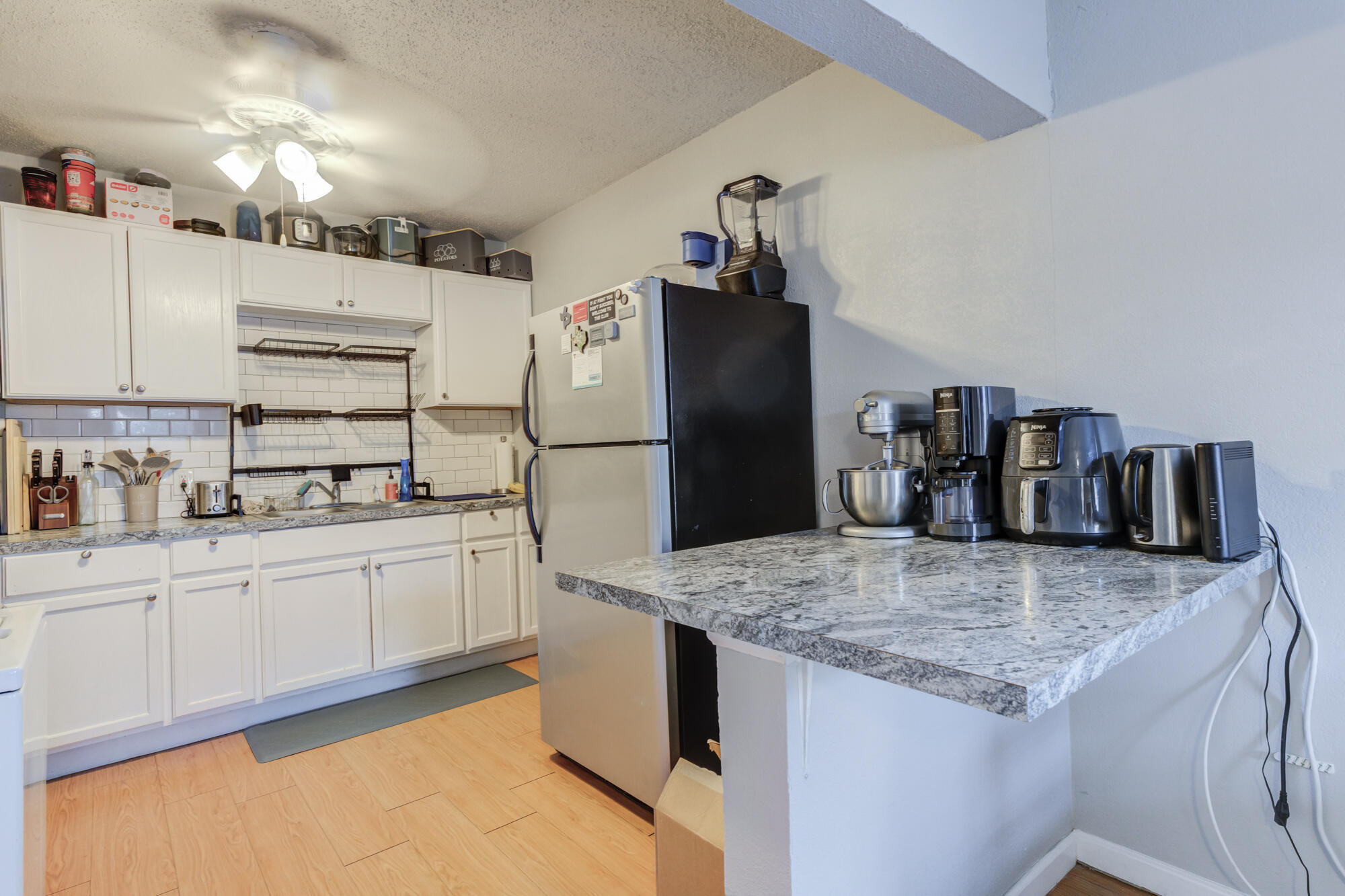2601 25th Street Lubbock, TX 79410 - Photo 15 of 30 a kitchen with granite countertop a refrigerator and a sink