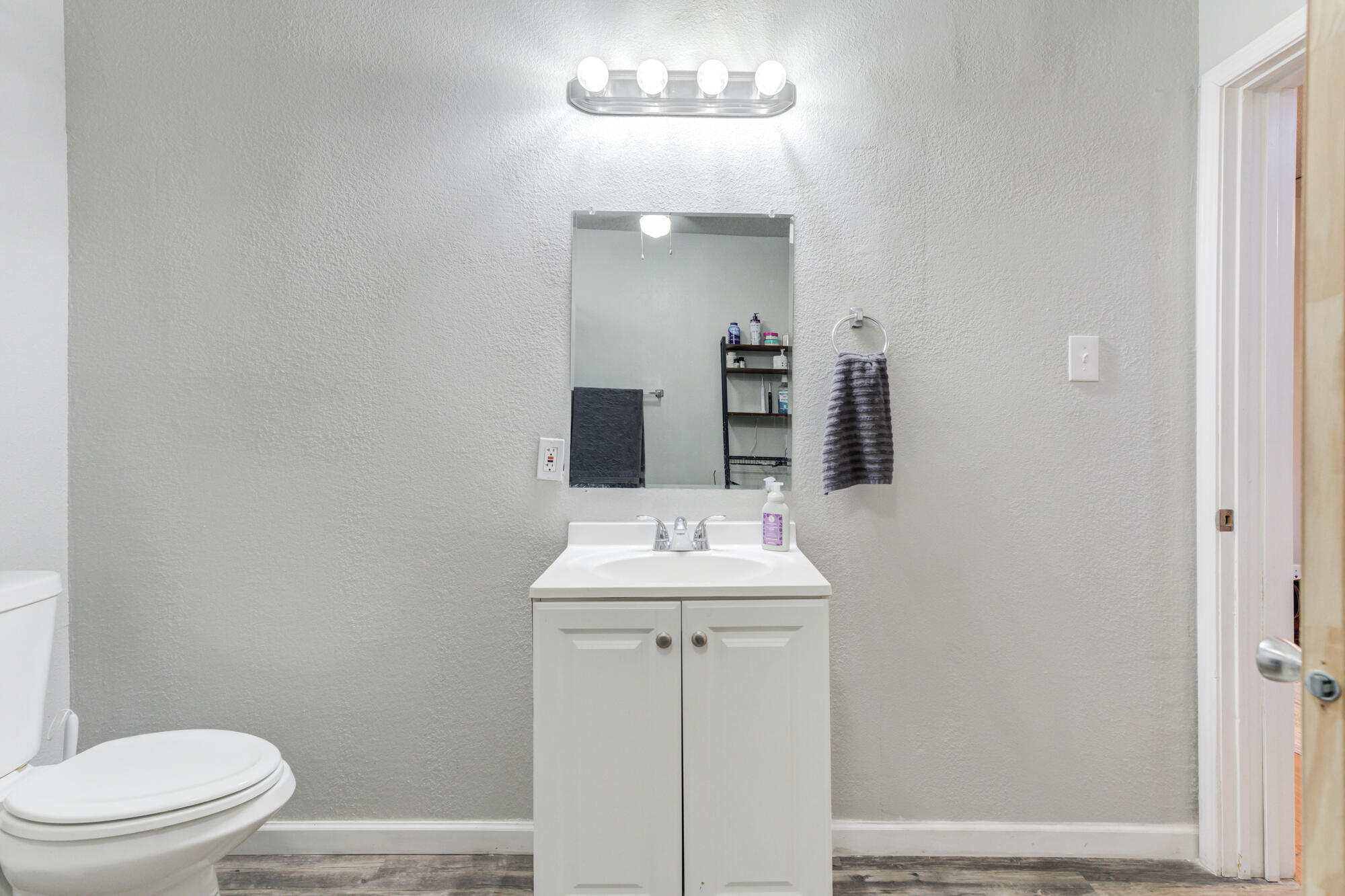 2601 25th Street Lubbock, TX 79410 - Photo 20 of 30 a bathroom with a sink vanity mirror and toilet