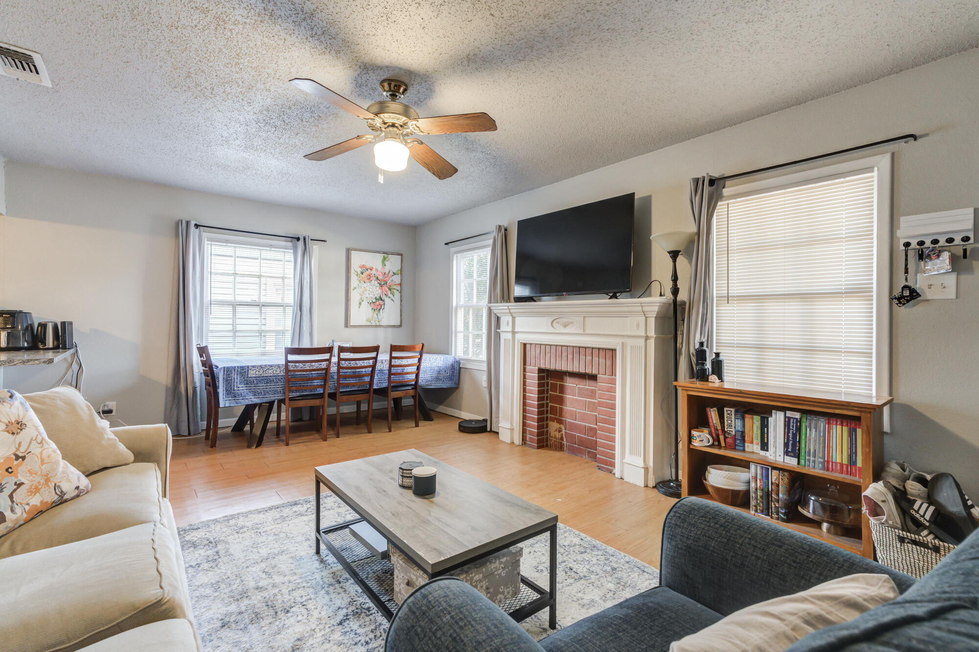 2601 25th Street Lubbock, TX 79410 - Photo 2 of 30 a living room with furniture a fireplace and a flat screen tv