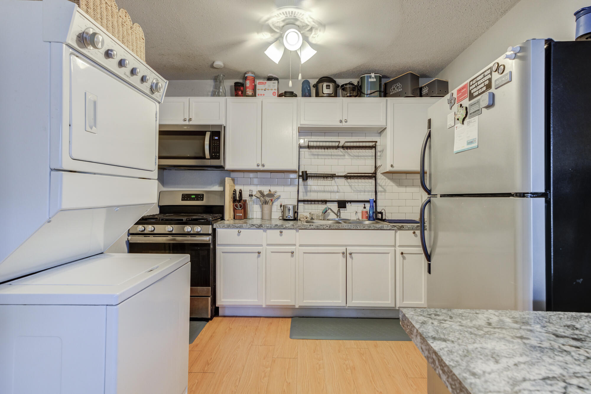 2601 25th Street Lubbock, TX 79410 - Photo 3 of 30 a kitchen with stainless steel appliances granite countertop a stove a sink and a refrigerator