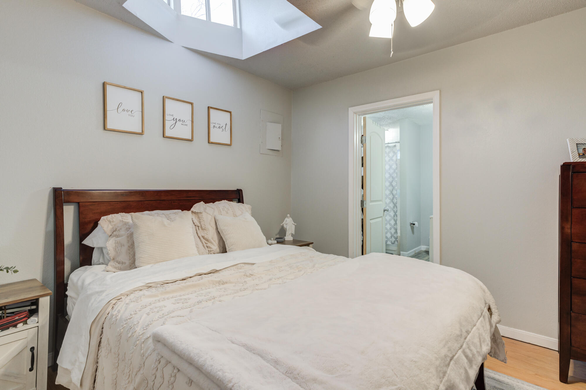 2601 25th Street Lubbock, TX 79410 - Photo 4 of 30 a large bed in a bedroom next to a window