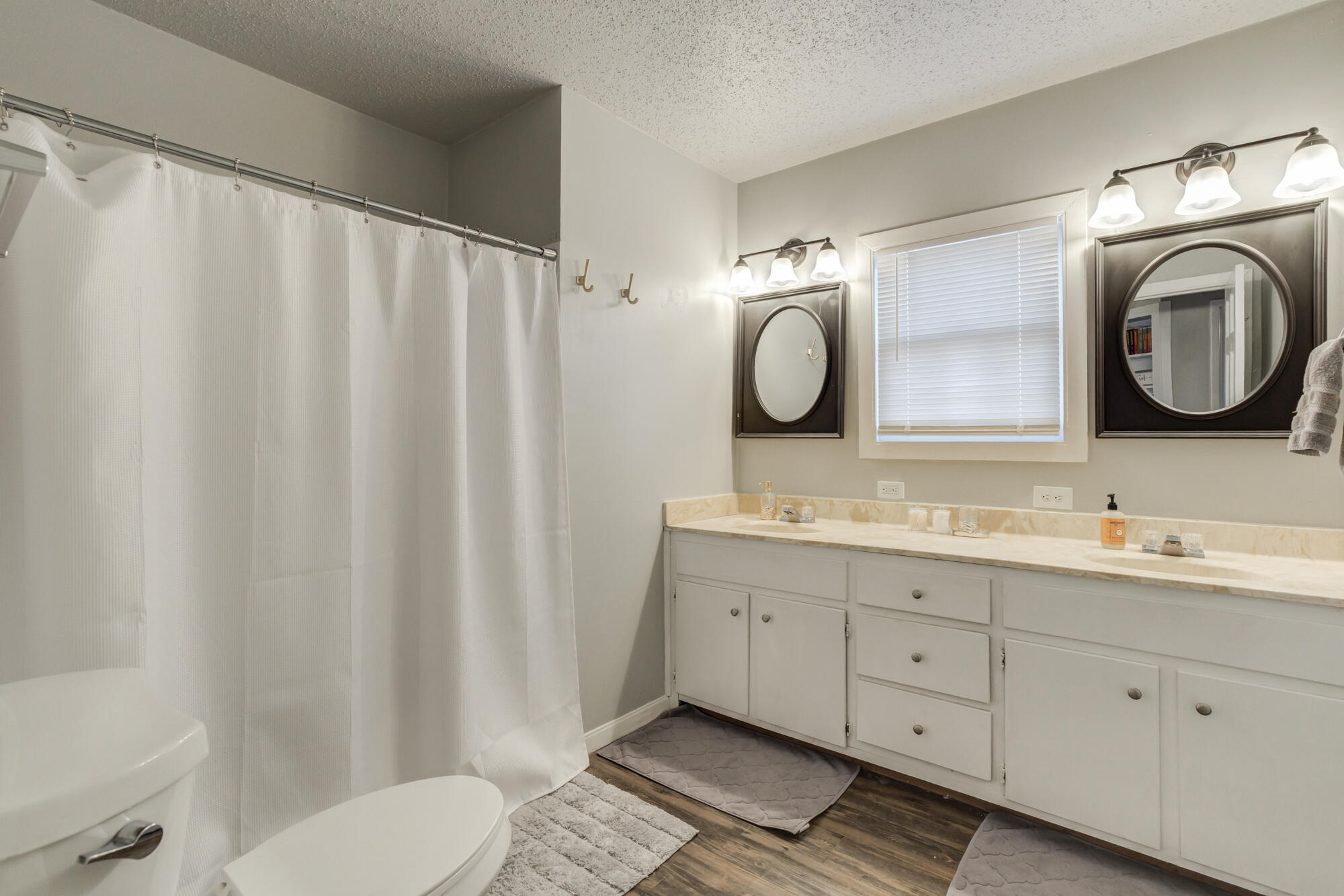 2601 25th Street Lubbock, TX 79410 - Photo 5 of 30 a bathroom with a double vanity sink and mirror