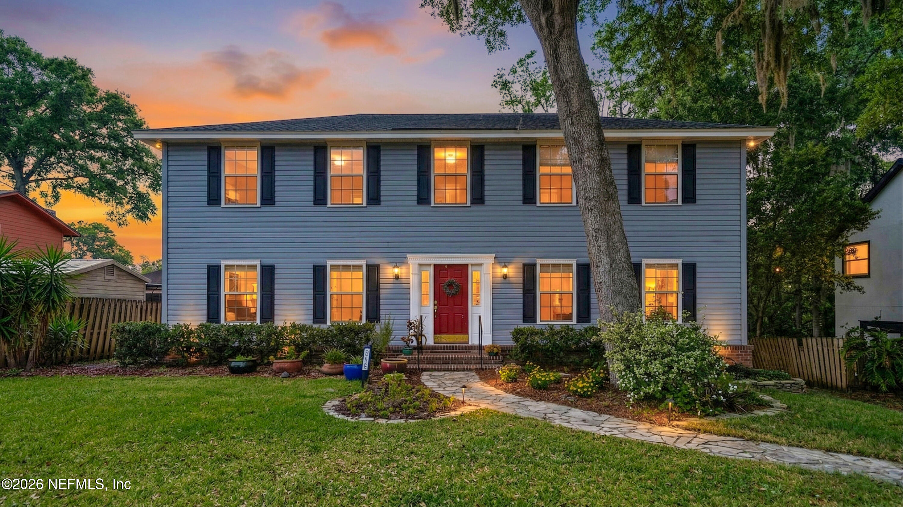 a front view of a house with porch and garden