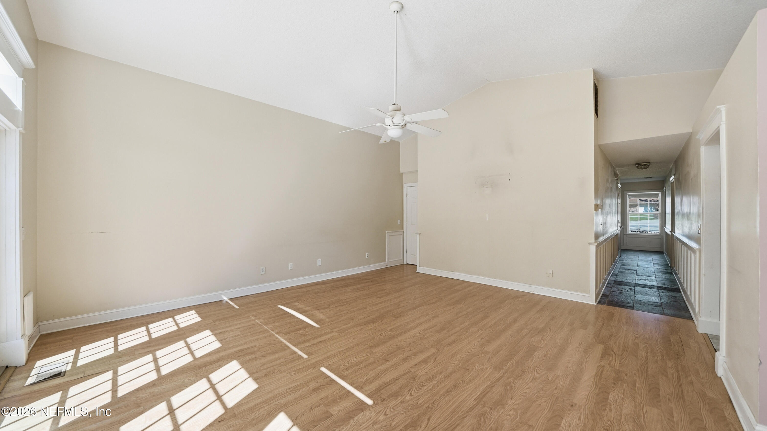 2216 Brentfield Road Jacksonville, FL 32225 - Photo 16 of 62 an empty room with wooden floor and windows
