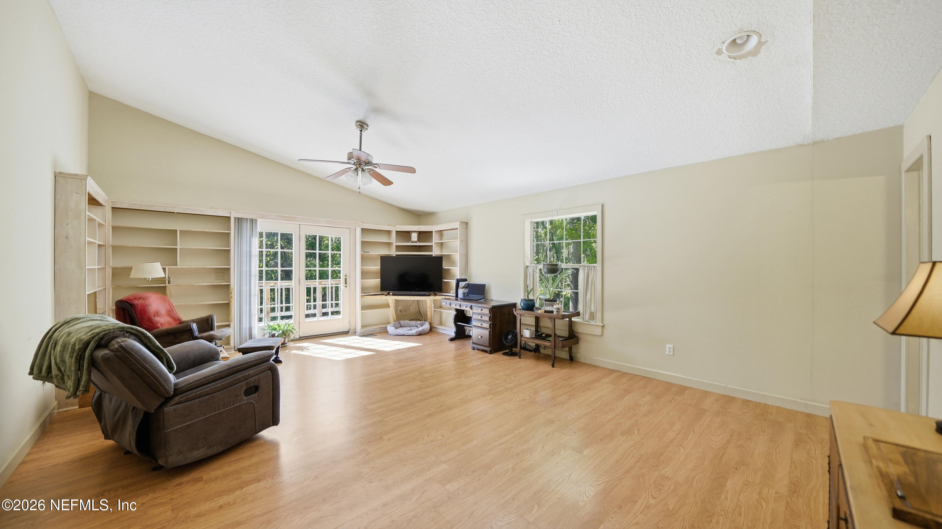 2216 Brentfield Road Jacksonville, FL 32225 - Photo 19 of 62 a living room with furniture a flat screen tv and a large window