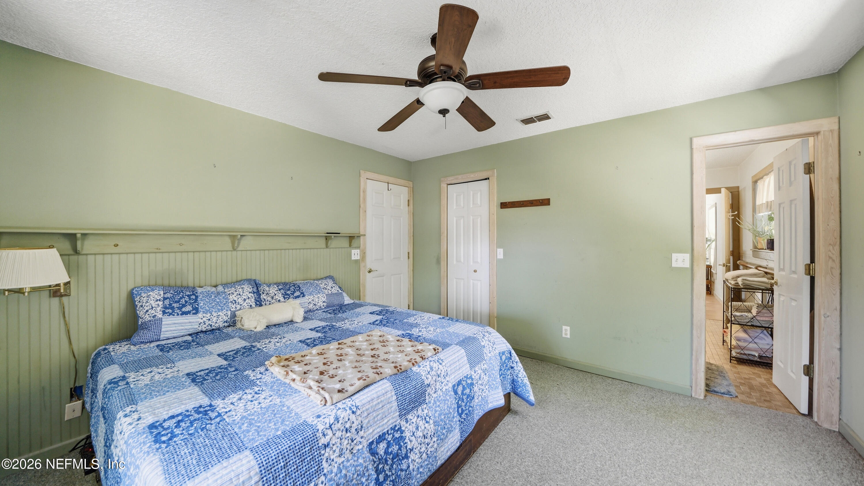 2216 Brentfield Road Jacksonville, FL 32225 - Photo 26 of 62 a bedroom with a bed and a chandelier