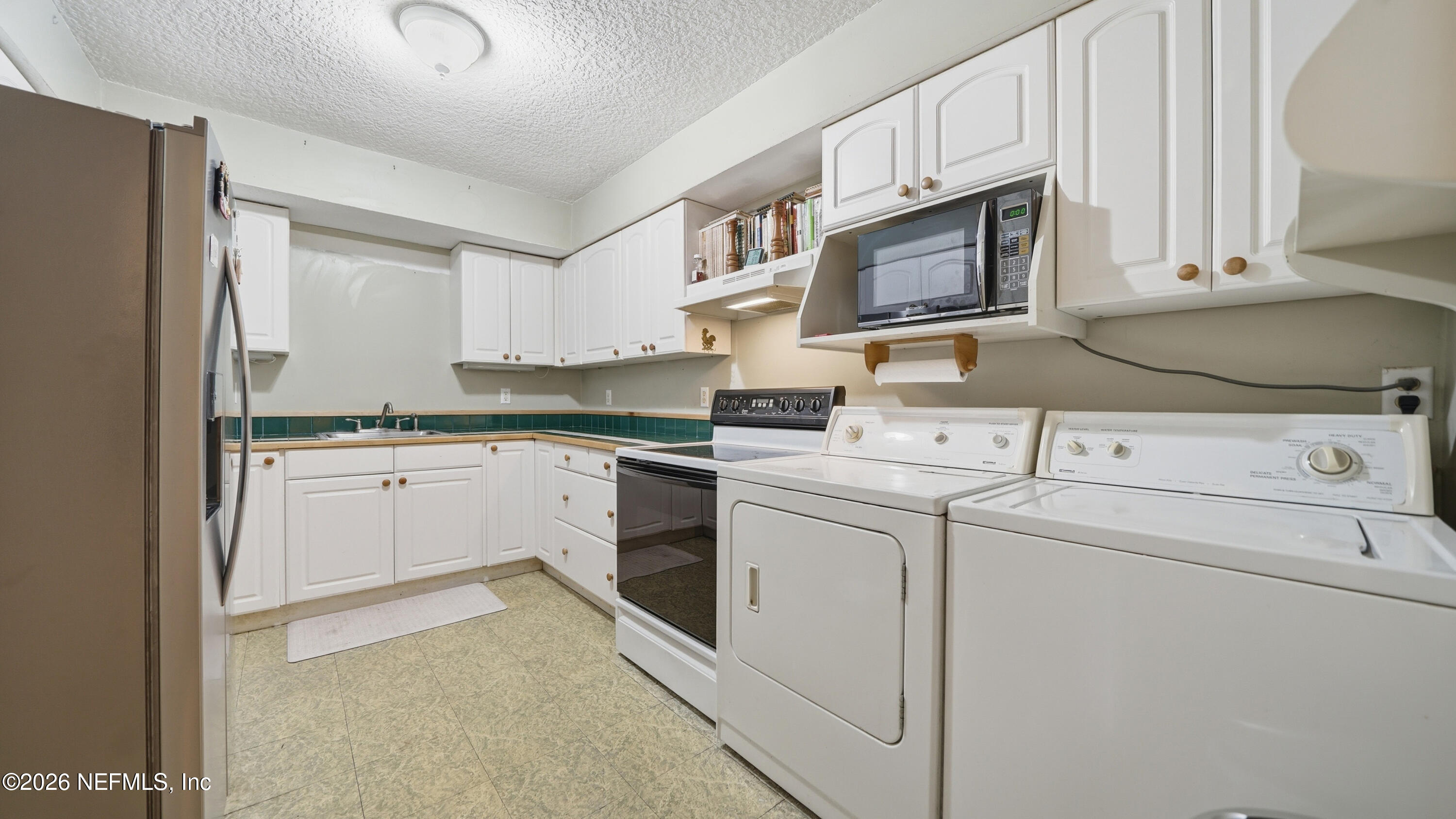 2216 Brentfield Road Jacksonville, FL 32225 - Photo 27 of 62 a kitchen with cabinets stainless steel appliances and sink