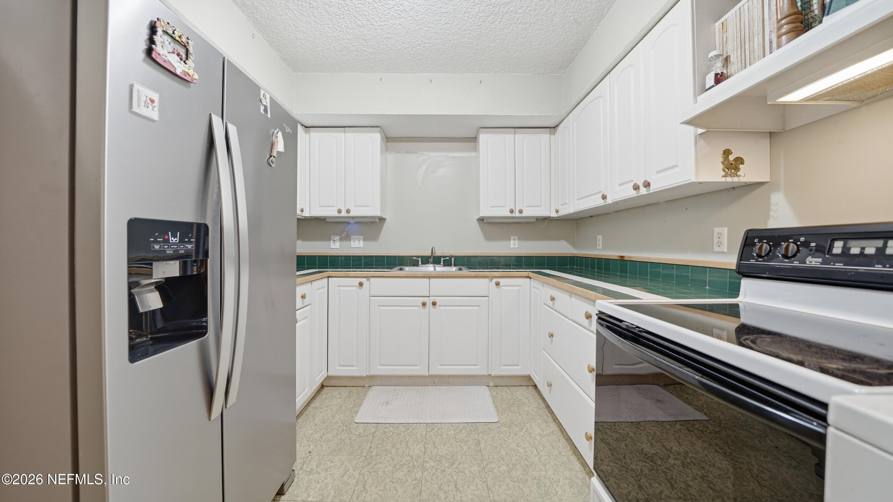 2216 Brentfield Road Jacksonville, FL 32225 - Photo 28 of 62 a kitchen with granite countertop a refrigerator stove and sink