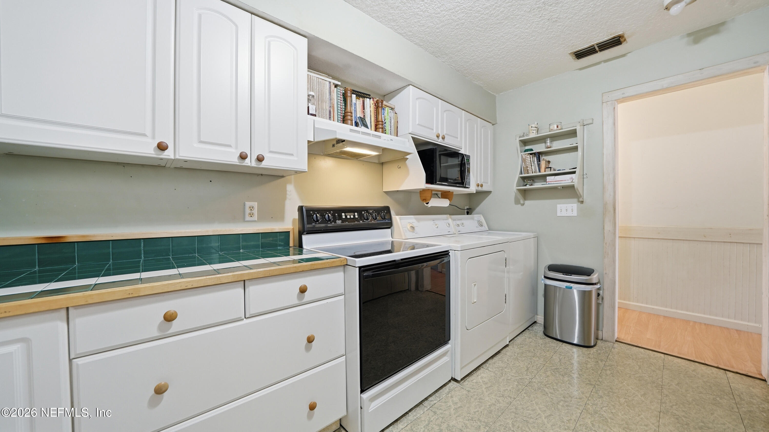 2216 Brentfield Road Jacksonville, FL 32225 - Photo 29 of 62 a kitchen with stainless steel appliances granite countertop a stove a sink and a refrigerator