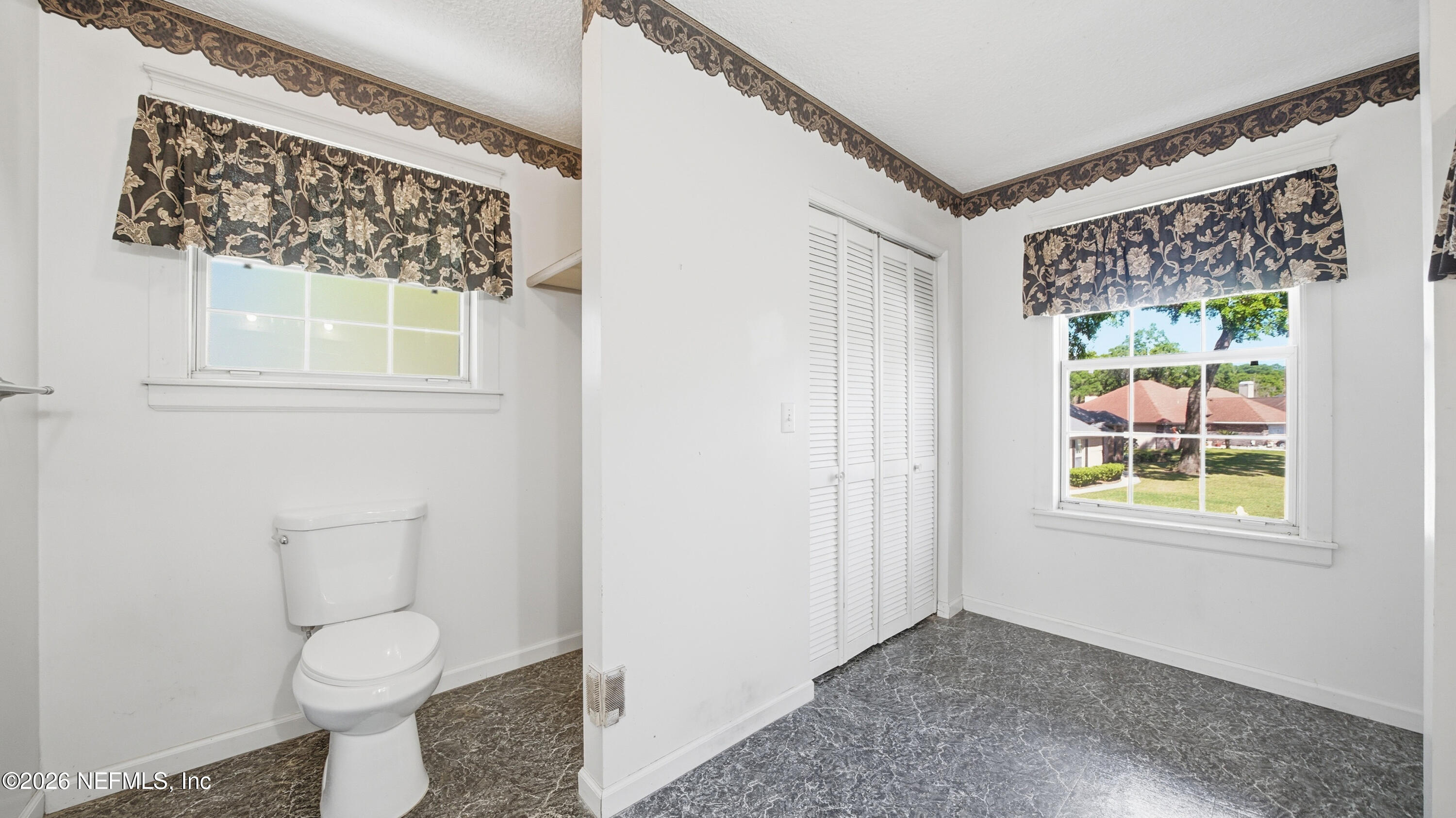 2216 Brentfield Road Jacksonville, FL 32225 - Photo 38 of 62 a bathroom with a toilet a sink and a window