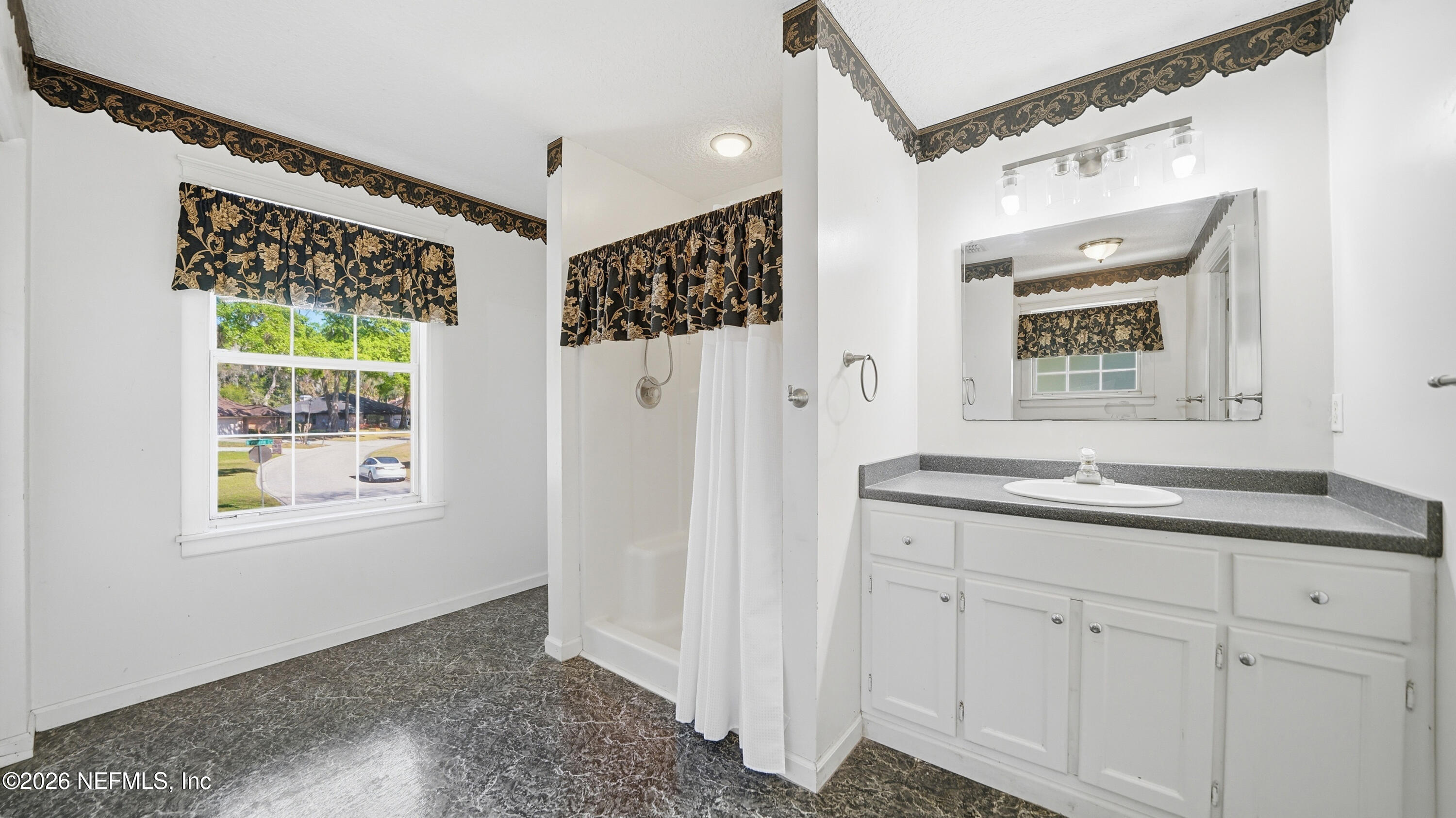 2216 Brentfield Road Jacksonville, FL 32225 - Photo 39 of 62 a bathroom with a granite countertop sink mirror and a shower
