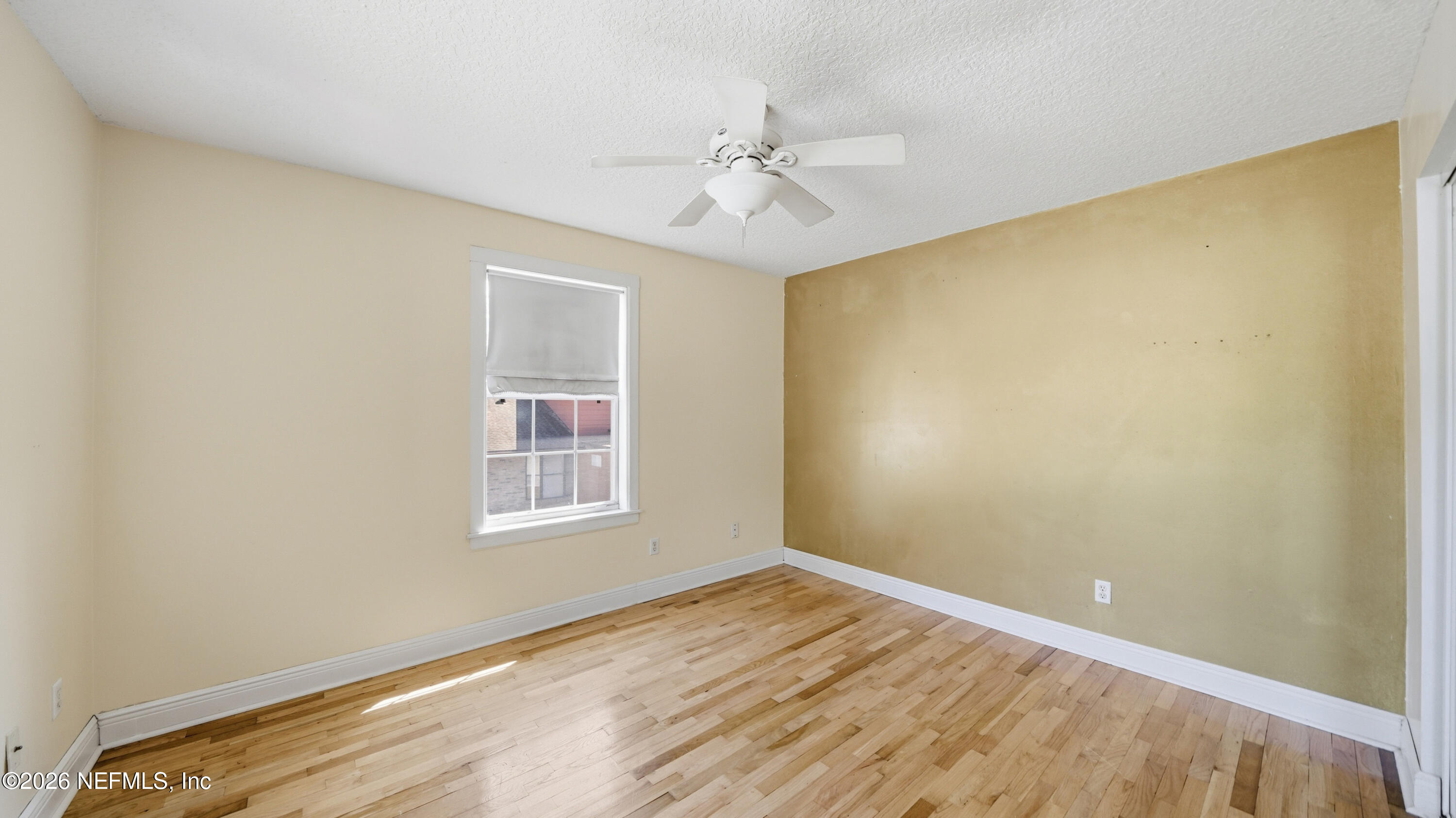 2216 Brentfield Road Jacksonville, FL 32225 - Photo 40 of 62 a view of an empty room with wooden floor and a window