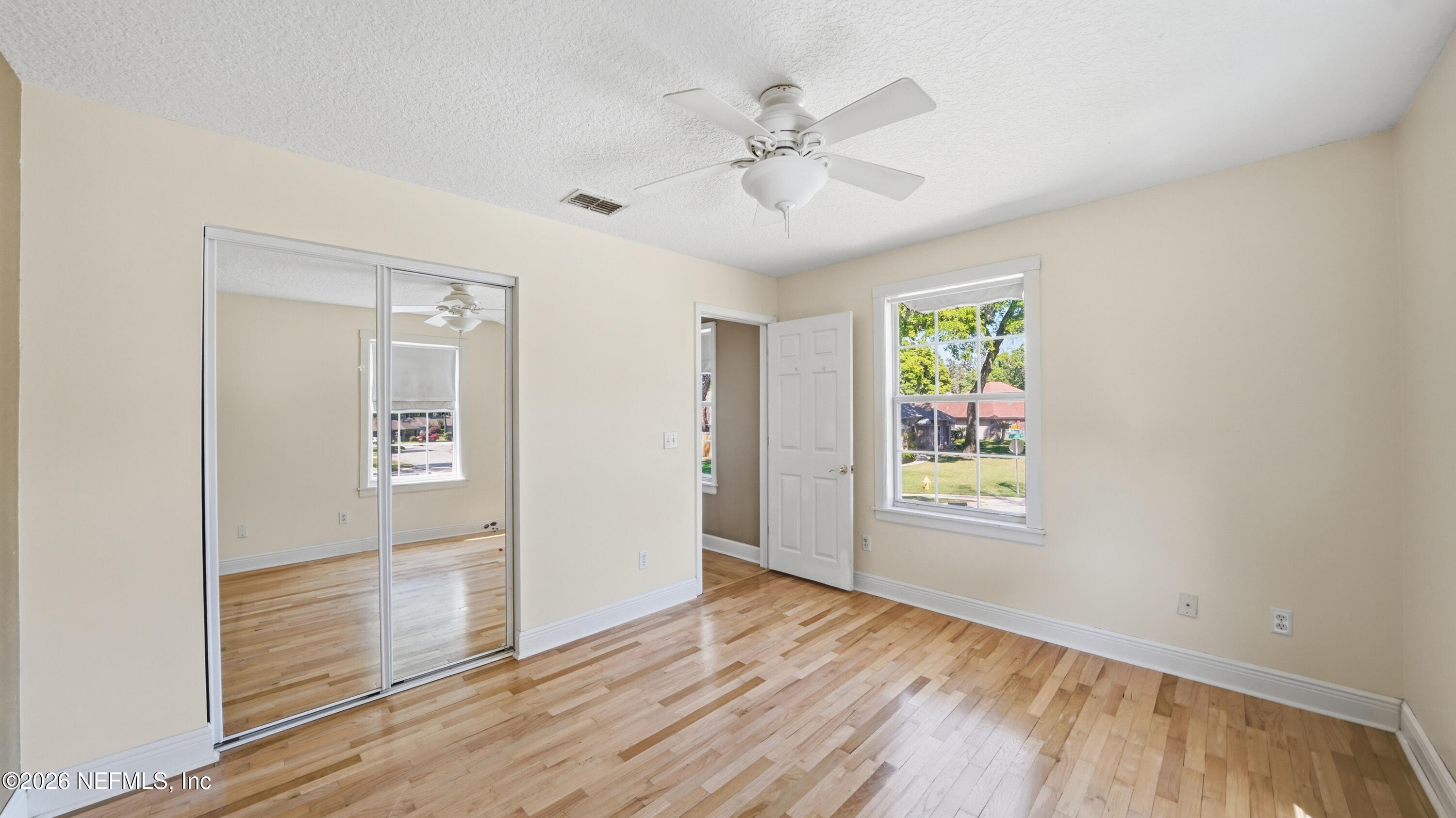 2216 Brentfield Road Jacksonville, FL 32225 - Photo 41 of 62 wooden floor in an empty room with a window