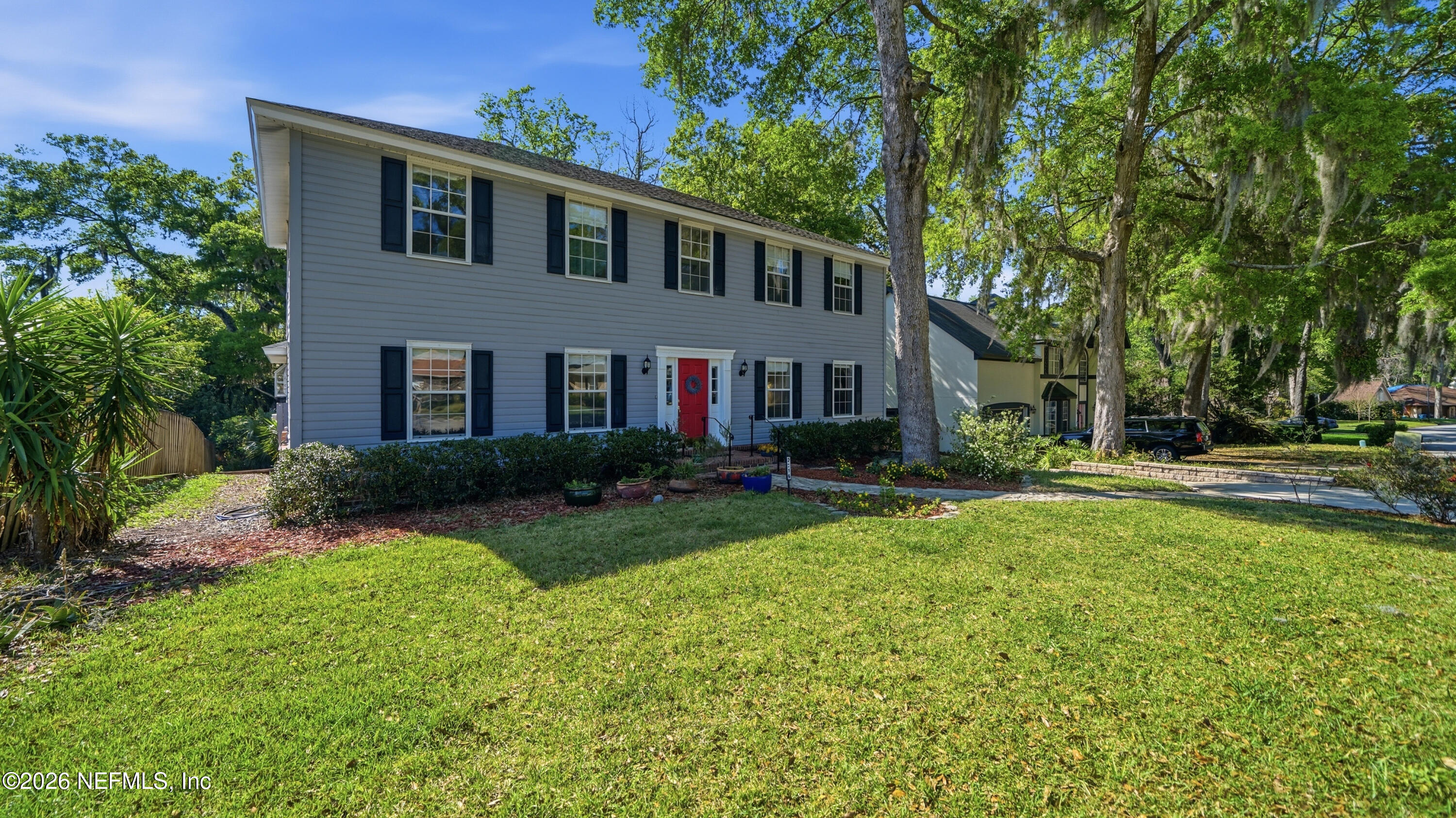 2216 Brentfield Road Jacksonville, FL 32225 - Photo 57 of 62 a front view of a house with garden and trees