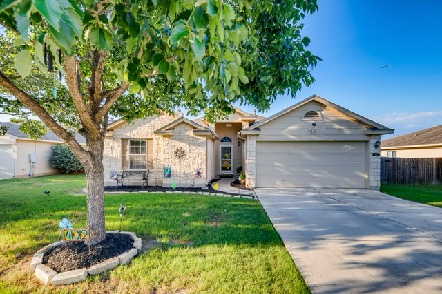 402 Atlantis Kyle, TX 78640 - Photo 1 of 1 a front view of a house with a yard and garage