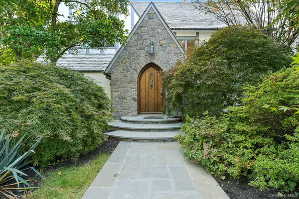 a front view of a house with garden