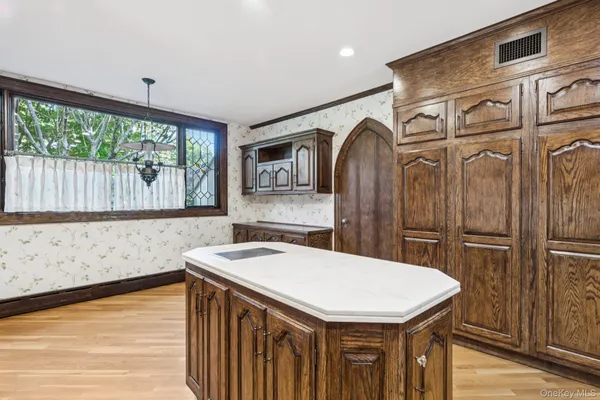 a kitchen with a sink a refrigerator and a window