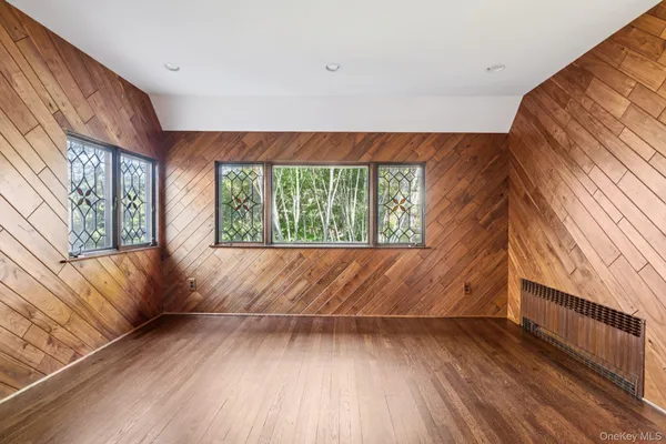 a view of room with window and wooden floor