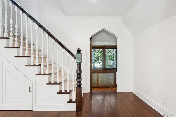 a view of entryway with wooden floor and stairs