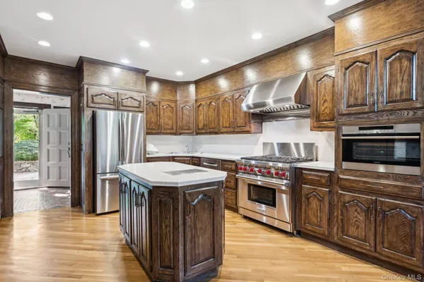 a kitchen with stainless steel appliances granite countertop a stove and a refrigerator