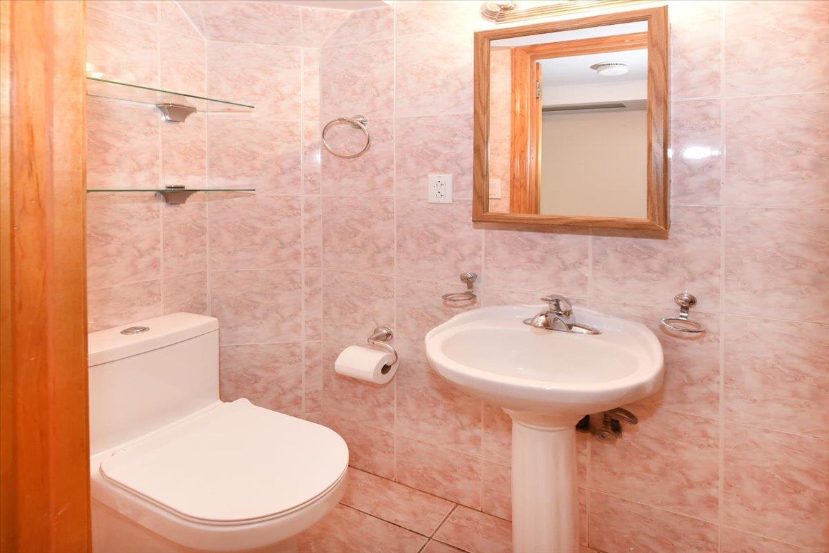 150-15 78th Road Queens, NY 11367 - Photo 13 of 28 Bathroom with tile walls and toilet