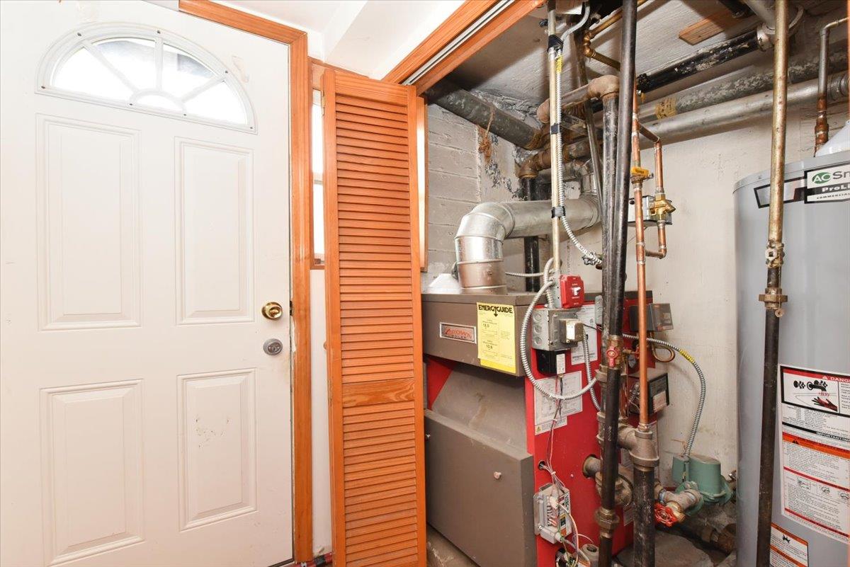 150-15 78th Road Queens, NY 11367 - Photo 26 of 28 Utility room featuring water heater