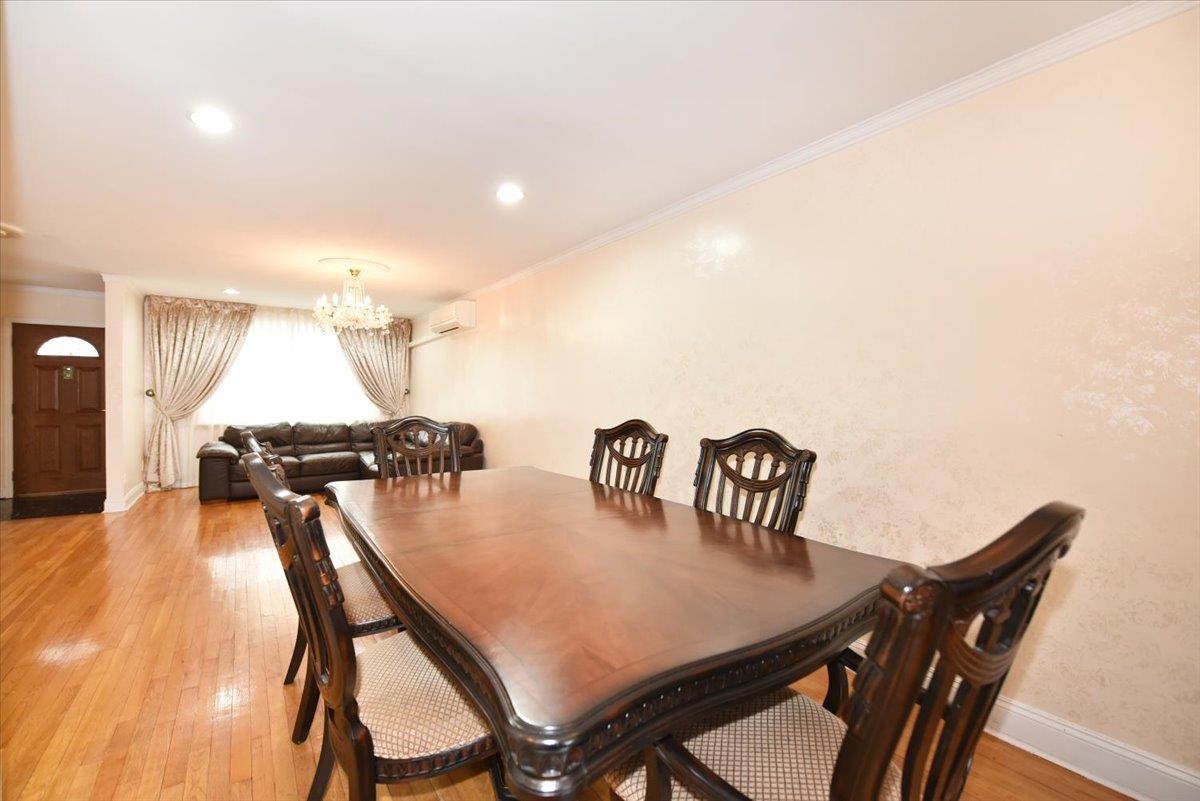 150-15 78th Road Queens, NY 11367 - Photo 9 of 28 Dining space featuring light wood-style flooring, baseboards, a chandelier, and ornamental molding