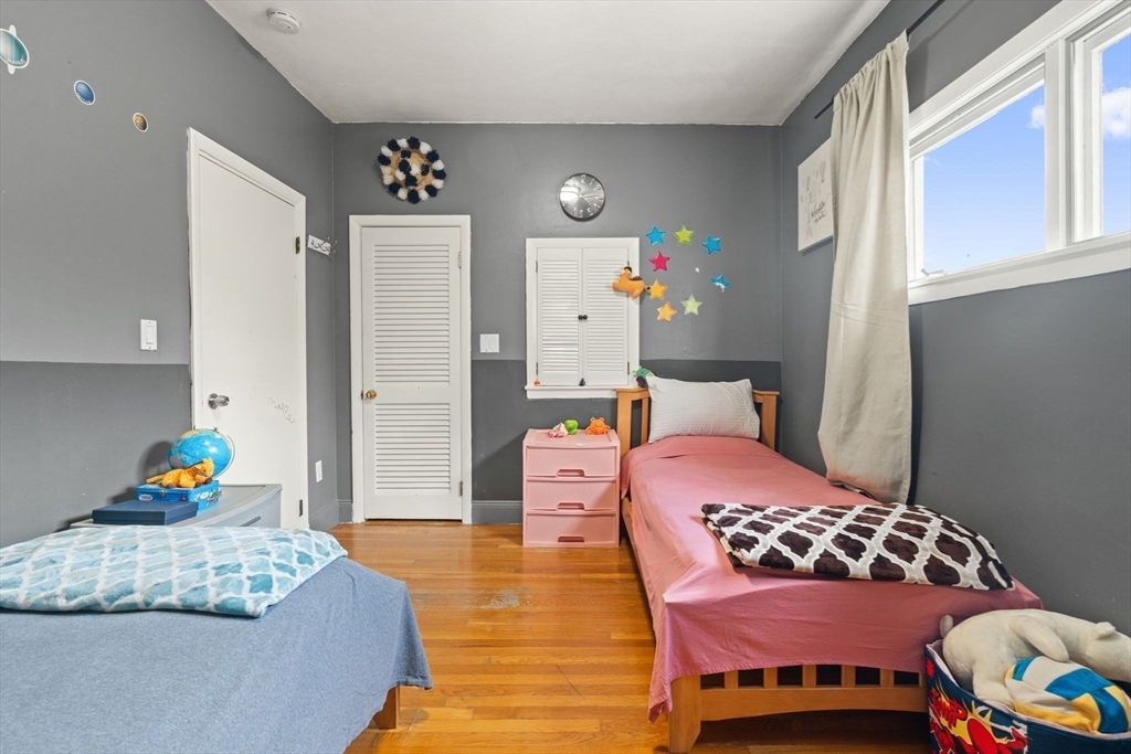 48 Tapped Street Everett, MA 02149 - Photo 11 of 24 a bedroom with a bed and wooden floor