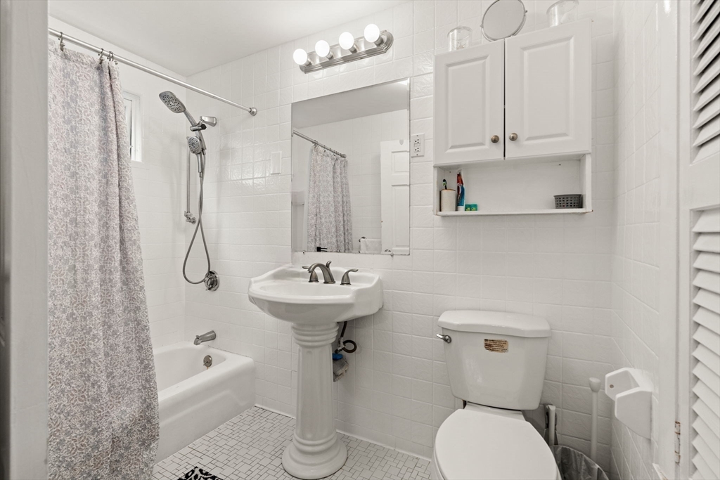 48 Tapped Street Everett, MA 02149 - Photo 16 of 24 a bathroom with a sink a toilet and shower