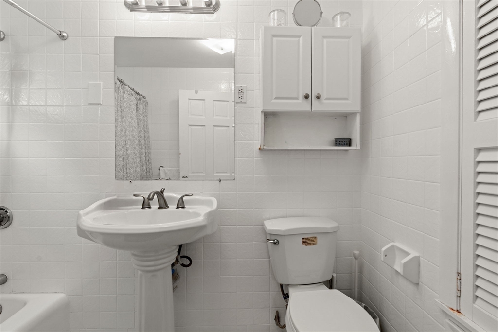 48 Tapped Street Everett, MA 02149 - Photo 17 of 24 a bathroom with a sink a toilet and mirror