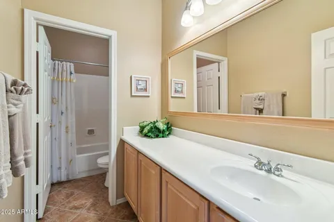 a spacious bathroom with a sink and a mirror