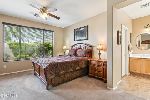 a bedroom with a bed next to a window