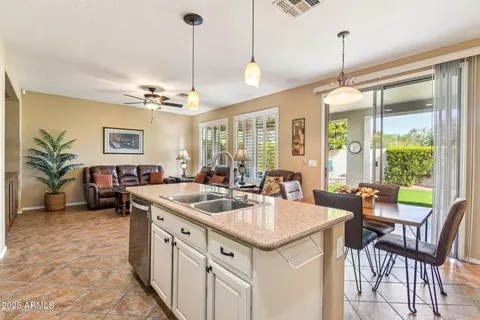 a kitchen with a stove a sink a table and chairs