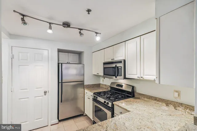 a kitchen with a refrigerator stove and microwave