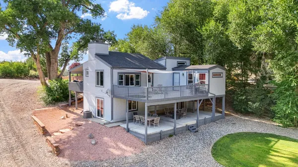 an aerial view of a house with backyard porch and sitting area