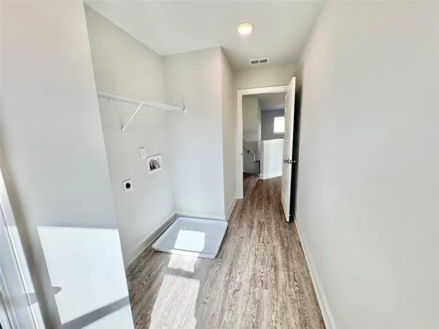 a view of hallway with wooden floor