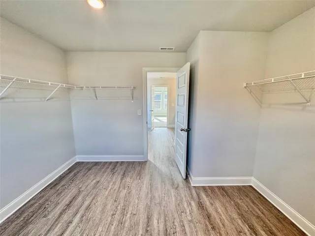 a view of a room with wooden floor and window