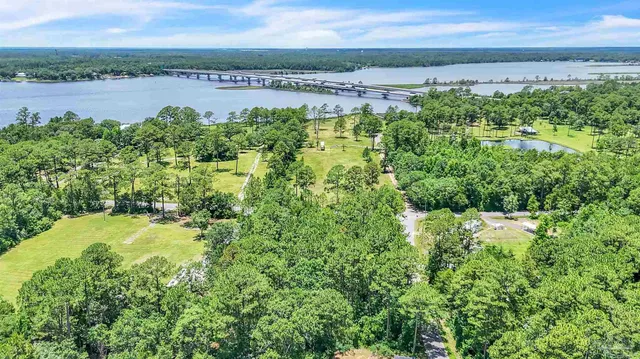 a view of a lake in middle of a field