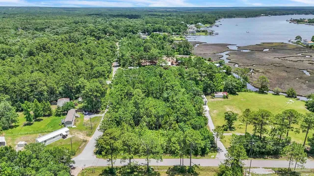 an aerial view of a houses with yard
