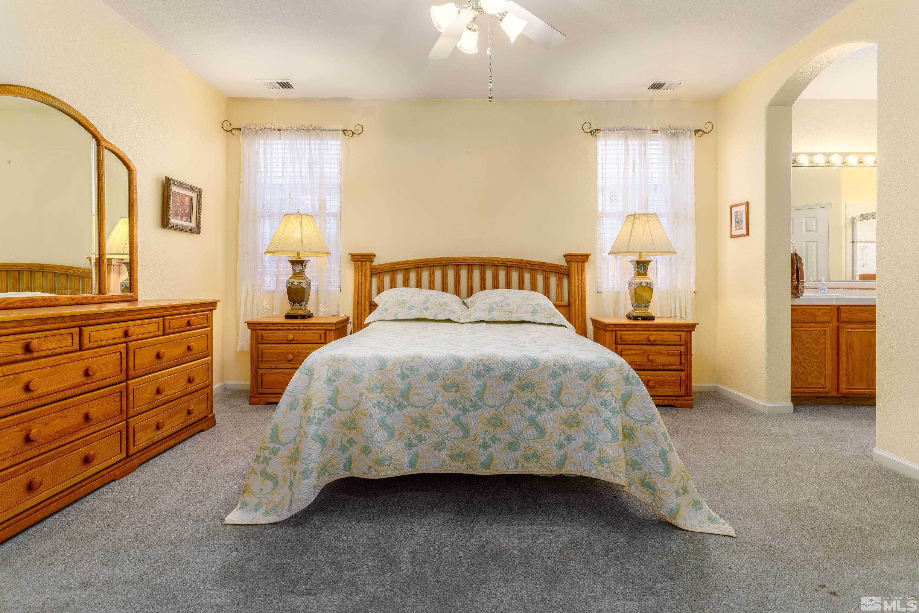10412 Rockport Lane Reno, NV 89521 - Photo 7 of 15 a spacious bedroom with a bed and a cabinets