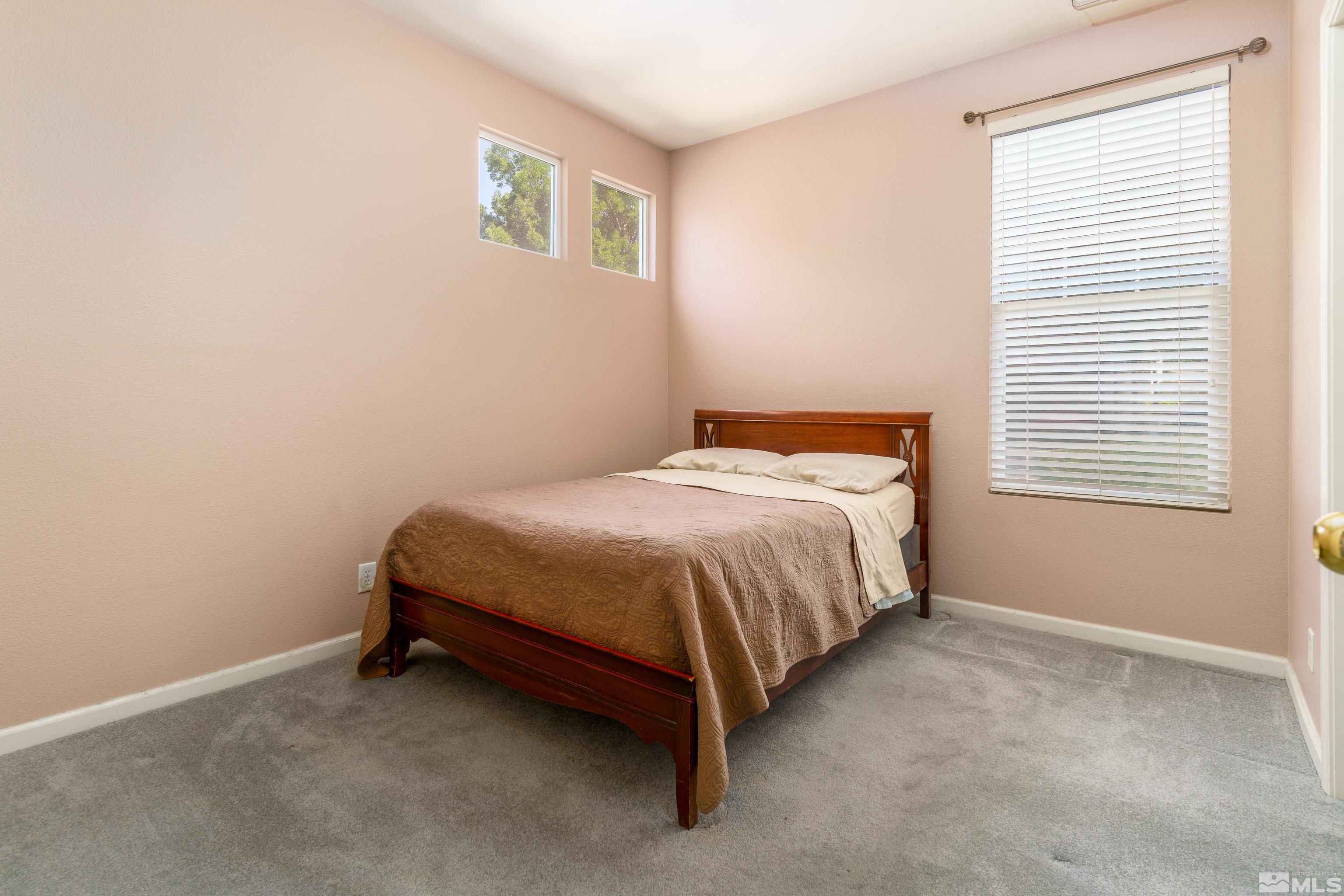 10412 Rockport Lane Reno, NV 89521 - Photo 9 of 15 a bed sitting in a bedroom next to a window