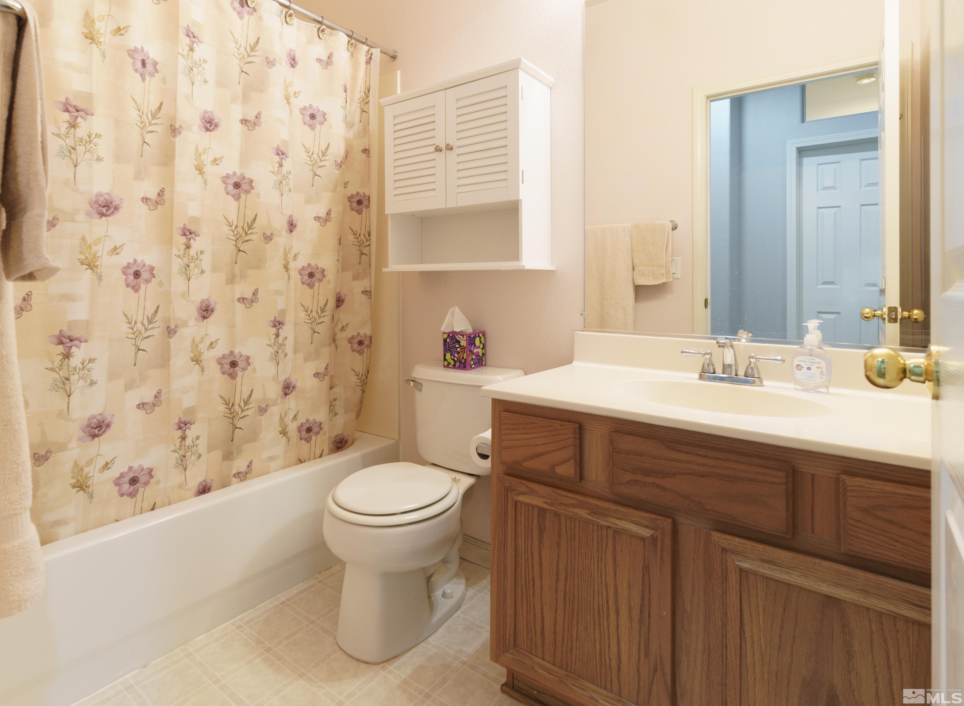 10412 Rockport Lane Reno, NV 89521 - Photo 10 of 15 a bathroom with a sink toilet and shower
