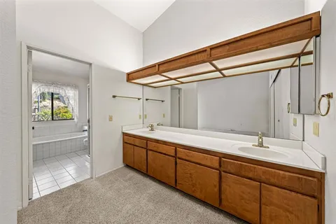 a bathroom with a double vanity sink and mirror