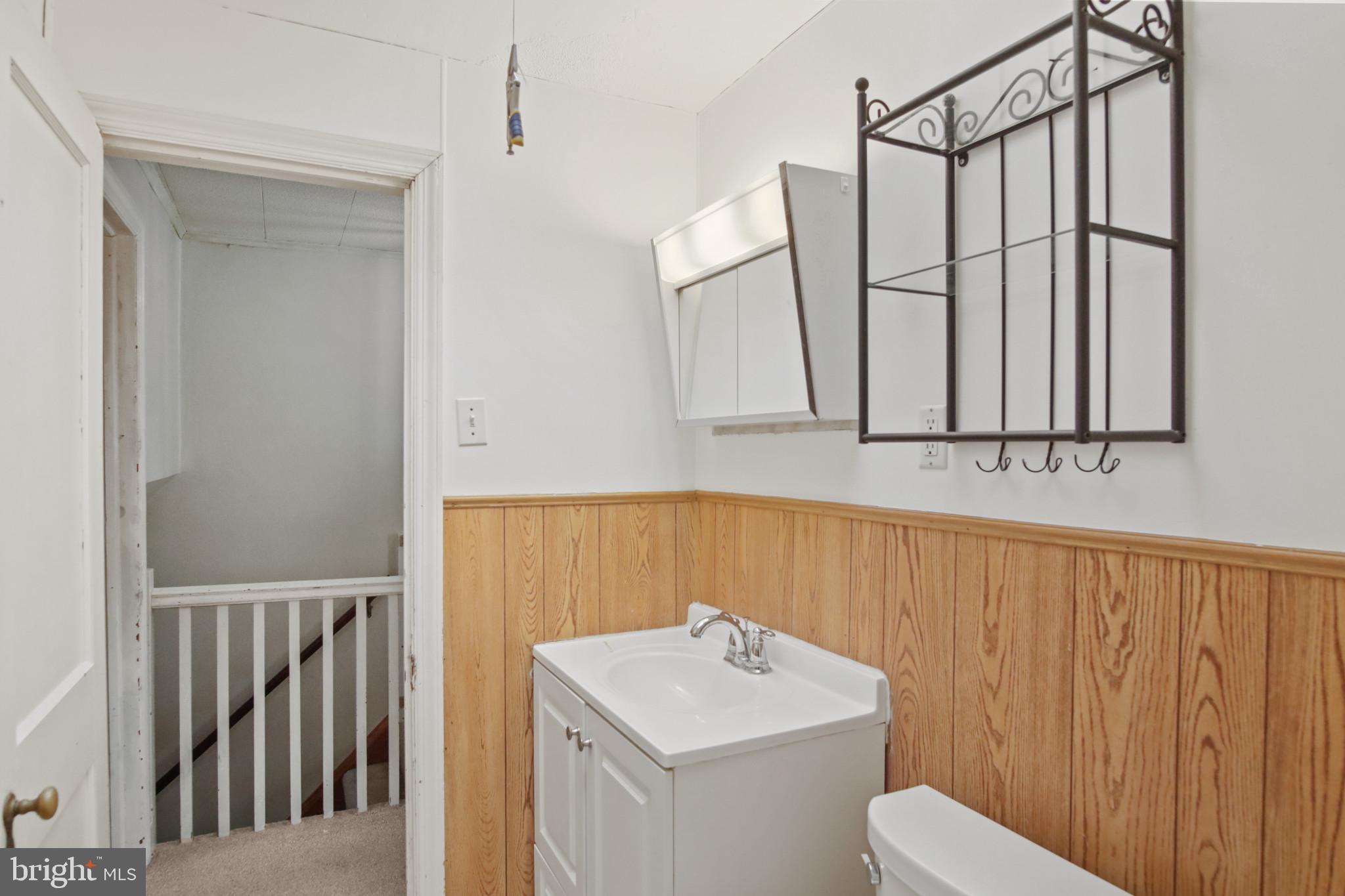 102 Willow Spring Road Baltimore, MD 21222 - Photo 19 of 28 a bathroom with a sink a toilet and shower