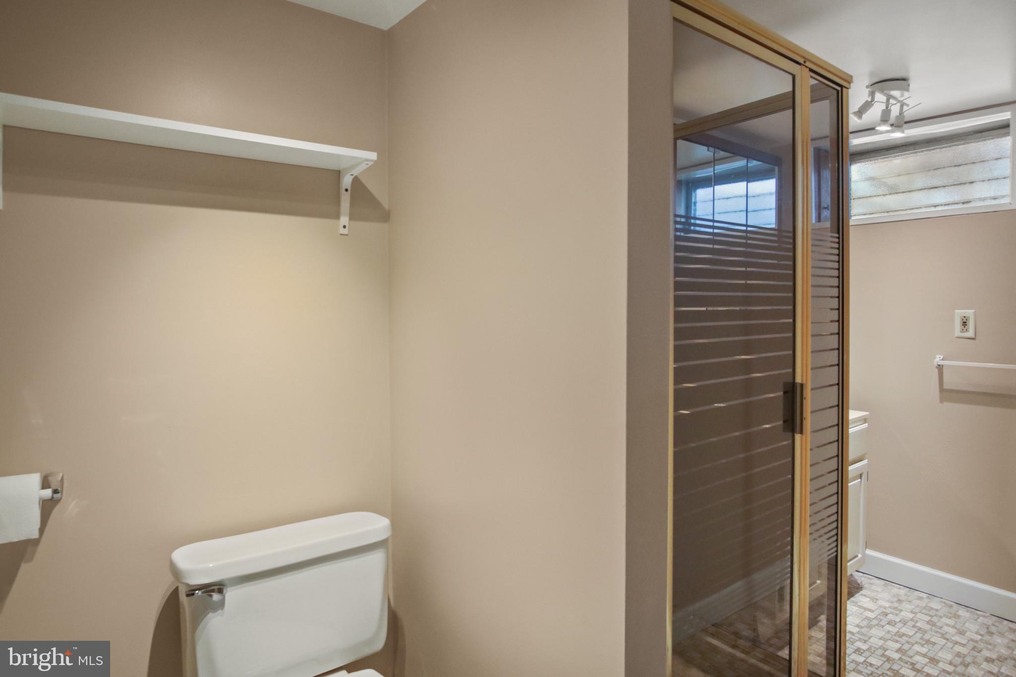 102 Willow Spring Road Baltimore, MD 21222 - Photo 22 of 28 a white toilet sitting next to a shower