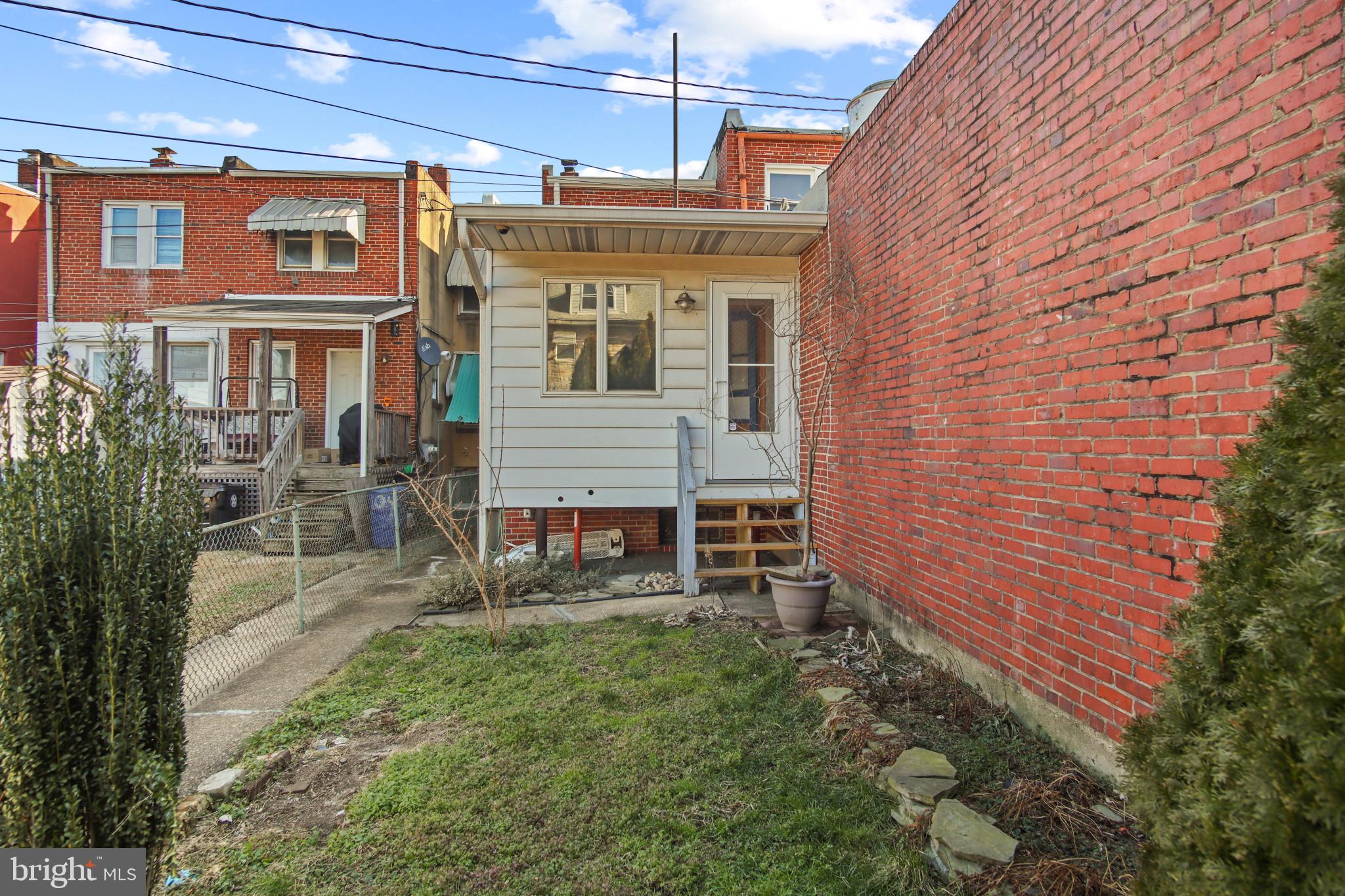 102 Willow Spring Road Baltimore, MD 21222 - Photo 28 of 28 a front view of a house with garden